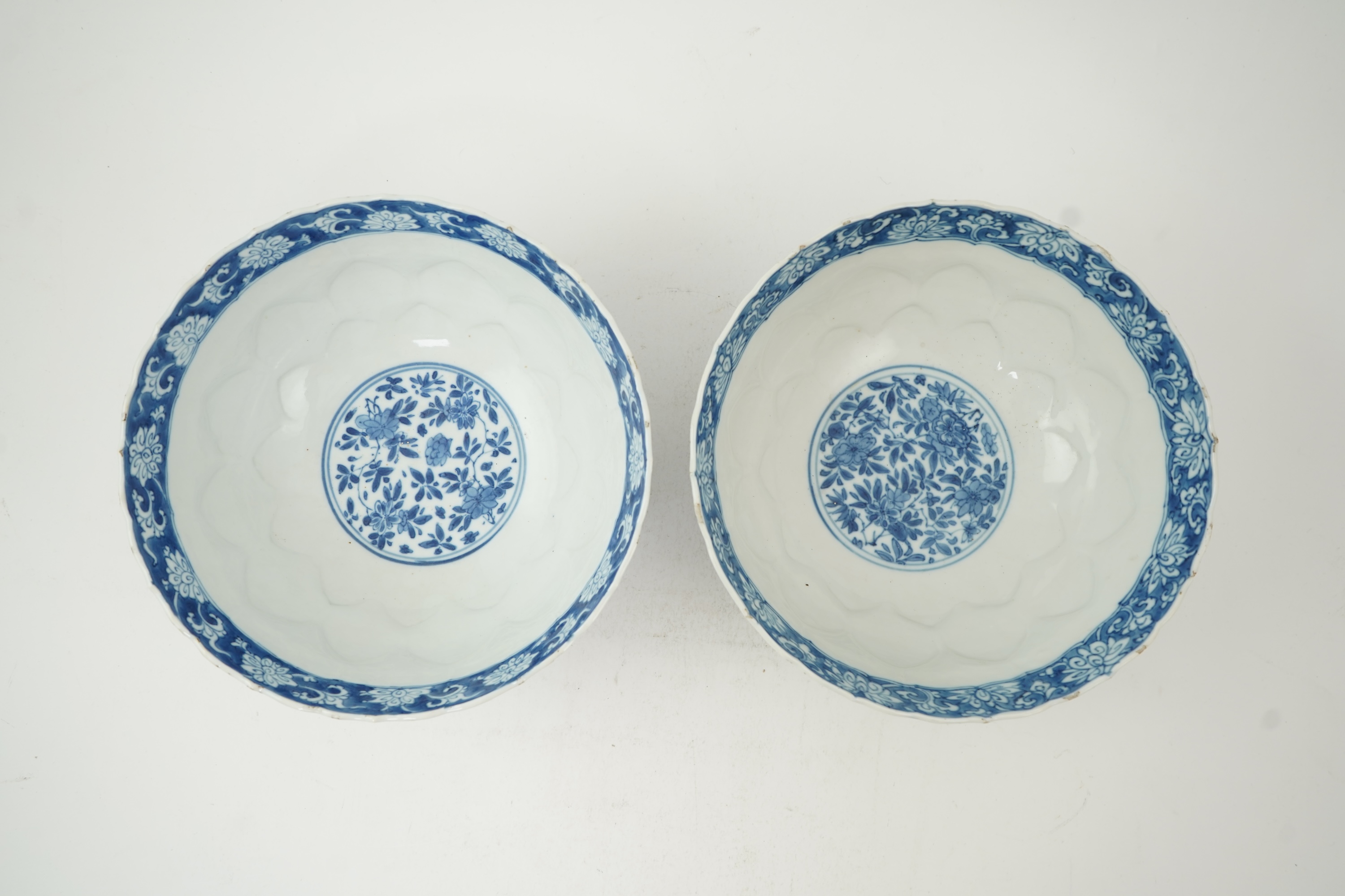 A near pair of Chinese blue and white lotus flower moulded bowls, Kangxi period
